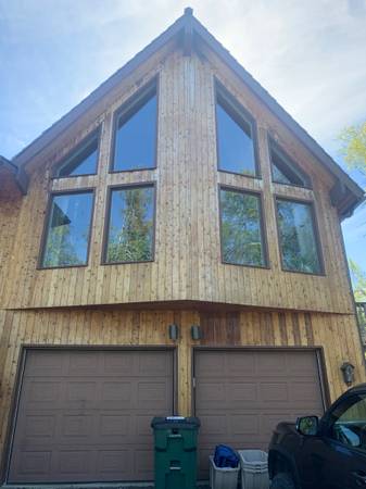 Exterior home with multiple white replacement windows